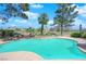 Tranquil swimming pool overlooking a lush, green landscape with clear blue sky, enhancing the home's appeal at 1848 Indian Bend Dr, Henderson, NV 89074