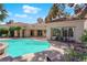 Stunning backyard pool with tiled stairs, a scenic view, and comfortable seating, perfect for outdoor enjoyment at 1848 Indian Bend Dr, Henderson, NV 89074