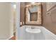 Unique powder room with shell-framed mirror, pedestal sink, and beadboard wainscoting offering charming detail at 1848 Indian Bend Dr, Henderson, NV 89074