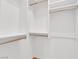 Bright walk-in closet featuring white shelving, gold rods, and ample storage space for an organized wardrobe at 1848 Indian Bend Dr, Henderson, NV 89074