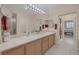Bathroom with dual sink vanity and large mirror and framed view of bedroom at 1912 Summer Pine Ct # 103, Las Vegas, NV 89134