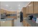 Spacious kitchen features granite countertops, wooden cabinets, and stainless steel appliances at 1912 Summer Pine Ct # 103, Las Vegas, NV 89134