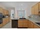 Kitchen featuring granite countertops, black appliances, and plenty of cabinet storage at 1912 Summer Pine Ct # 103, Las Vegas, NV 89134