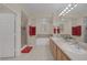 Bright bathroom with double sinks, bath tub, shower stall, and red towels at 1912 Summer Pine Ct # 103, Las Vegas, NV 89134