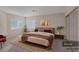 Staged primary bedroom boasts an accent wall, ample windows and an inviting decor at 1912 Summer Pine Ct # 103, Las Vegas, NV 89134