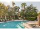 Enjoy the community pool and lounge area amidst beautiful landscaping and towering palm trees at 1912 Summer Pine Ct # 103, Las Vegas, NV 89134