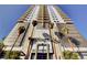 Modern high-rise building exterior featuring sleek architectural details and palm tree landscaping at 200 Hoover Ave # 912, Las Vegas, NV 89101