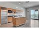 Modern kitchen featuring stainless steel appliances, center island and natural light from the sliding glass door at 200 Hoover Ave # 912, Las Vegas, NV 89101