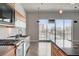 Modern kitchen featuring stainless steel appliances, sleek countertops, and city views from the large window at 200 Hoover Ave # 912, Las Vegas, NV 89101