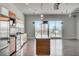 Bright kitchen with stainless steel appliances, an island, and a sliding glass door providing natural light and city views at 200 Hoover Ave # 912, Las Vegas, NV 89101