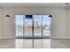Bright living area features sliding glass doors with city views and modern pendant lighting at 200 Hoover Ave # 912, Las Vegas, NV 89101