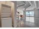 View of an open-concept living space showcasing a washer/dryer and kitchen with stainless steel appliances and island at 200 Hoover Ave # 912, Las Vegas, NV 89101