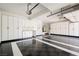 Spacious garage features epoxy flooring, ample built-in storage, and a well-organized layout for parking and projects at 209 Camino Vista St, Henderson, NV 89012