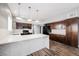 Modern kitchen features a large island, stylish backsplash, dark wood cabinetry, and stainless steel appliances at 209 Camino Vista St, Henderson, NV 89012