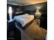 Cozy bedroom with neutral carpet, dark walls and a full sized bed at 210 E Flamingo Rd # 419, Las Vegas, NV 89169
