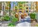 A condo complex featuring well-maintained landscaping and lush vegetation offering an inviting outdoor setting at 210 E Flamingo Rd # 419, Las Vegas, NV 89169