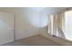 Neutral bedroom with carpet, window with curtains, and a door at 2141 Hussium Hills St # 102, Las Vegas, NV 89108