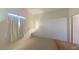 Bright bedroom features a window with curtains and a wall-mounted light fixture at 2141 Hussium Hills St # 102, Las Vegas, NV 89108