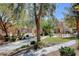 A beautiful community area with picnic tables, lush greenery, and a refreshing pool at 2141 Hussium Hills St # 102, Las Vegas, NV 89108