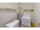 Functional laundry room with washer, water heater, and storage shelves, ready for immediate use at 2141 Hussium Hills St # 102, Las Vegas, NV 89108