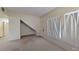 A bright living room featuring neutral paint, plush carpet, and a large sun-filled window at 2141 Hussium Hills St # 102, Las Vegas, NV 89108
