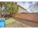 View of low maintenance backyard with a small patch of grass and basketball hoop at 2714 Cottonwillow St, Las Vegas, NV 89135