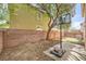 Cozy backyard featuring a basketball hoop, low-maintenance landscaping, and partial brick wall at 2714 Cottonwillow St, Las Vegas, NV 89135
