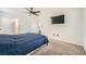 Spacious bedroom with a ceiling fan, television, and neutral carpet at 2714 Cottonwillow St, Las Vegas, NV 89135