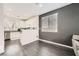 Open kitchen with white cabinets and stainless steel appliances near living area at 2714 Cottonwillow St, Las Vegas, NV 89135