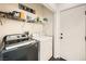 Laundry room featuring modern washer and dryer units, with storage shelves above at 2714 Cottonwillow St, Las Vegas, NV 89135