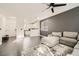 Living room view to kitchen with a ceiling fan and gray walls at 2714 Cottonwillow St, Las Vegas, NV 89135