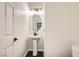 Elegant powder room featuring a pedestal sink, oval mirror, and modern lighting at 2714 Cottonwillow St, Las Vegas, NV 89135