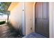 Elegant front entry with arched door, desert landscaping, and stone path at 31 Via Mantova # 1, Henderson, NV 89011