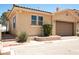 Single car garage featuring neutral paint with manicured desert landscaping in front yard at 31 Via Mantova # 1, Henderson, NV 89011