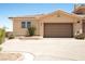 Single car garage featuring neutral paint with manicured desert landscaping in front yard at 31 Via Mantova # 1, Henderson, NV 89011