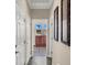 Inviting hallway with white doors and decorative art leading to bright living area at 31 Via Mantova # 1, Henderson, NV 89011