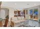 Open living room view of eat-in kitchen with tile floors, neutral colors, and large sliding glass doors at 31 Via Mantova # 1, Henderson, NV 89011