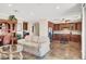 Open floor plan living room and kitchen featuring granite countertops and tile floors at 31 Via Mantova # 1, Henderson, NV 89011