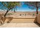 Scenic patio view overlooking desert landscape with mature trees, offering privacy at 31 Via Mantova # 1, Henderson, NV 89011