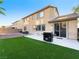 Well-maintained backyard featuring an artificial lawn, patio, and barbecue setup, perfect for outdoor entertaining and relaxation at 334 Shimmering Moon St, Henderson, NV 89015