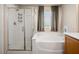Bathroom featuring a glass enclosed shower and separate bathtub, with neutral walls and hardware at 334 Shimmering Moon St, Henderson, NV 89015
