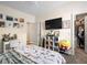 Comfortable bedroom with a TV, closet, and stylish furnishings at 334 Shimmering Moon St, Henderson, NV 89015