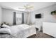 This bedroom features a bed, a wall-mounted TV, and a hanging hammock chair for relaxing in your room at 334 Shimmering Moon St, Henderson, NV 89015