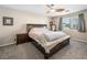 Bedroom with neutral walls, carpet floors, king size bed, side tables, and a ceiling fan for comfortable living at 334 Shimmering Moon St, Henderson, NV 89015