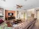 Bright living room with a large TV, comfortable couch, and staircase at 334 Shimmering Moon St, Henderson, NV 89015