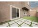Backyard featuring artificial turf and concrete tiling with a brick privacy wall at 376 Yellow Finch Ln, Henderson, NV 89012