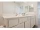 Bathroom boasts double sink vanity with contemporary fixtures, and large mirror at 376 Yellow Finch Ln, Henderson, NV 89012