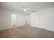 Spacious bedroom featuring neutral carpet, ceiling fan, with an open ensuite bathroom at 376 Yellow Finch Ln, Henderson, NV 89012