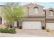 Home featuring a two-car garage, low maintenance landscaping, and neutral stucco at 376 Yellow Finch Ln, Henderson, NV 89012