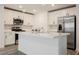 Well-equipped kitchen with white cabinets, quartz countertops, and stainless steel appliances at 376 Yellow Finch Ln, Henderson, NV 89012